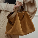 Large capacity genuine leather women's handbag with shoulder and crossbody straps, stylish cowhide tote for commuting.