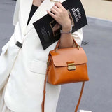 Vintage cow leather women’s handbag for commuters, structured design with carry handles and shoulder strap
