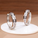 Elegant 925 sterling silver zircon earrings for women, featuring sparkling stones and a refined drop design