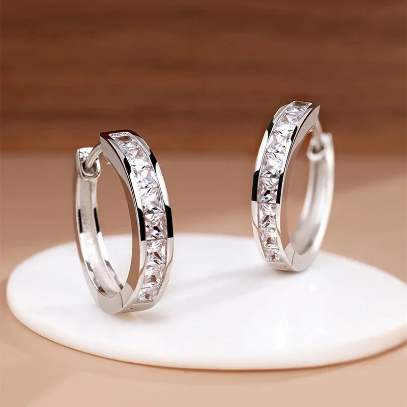 Elegant 925 sterling silver zircon earrings for women, featuring sparkling stones and a refined drop design