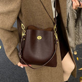Large capacity burgundy PU leather women's handbag with shoulder strap, elegant bucket style, suitable for fashion and daily use.