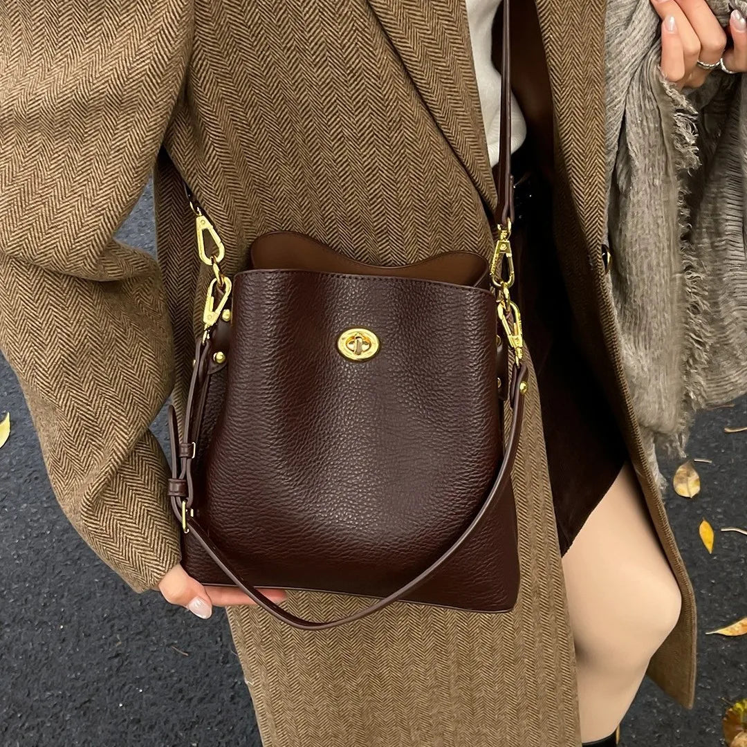 Large capacity burgundy PU leather women's handbag with shoulder strap, elegant bucket style, suitable for fashion and daily use.