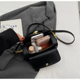 Black leather shoulder bag with textured flap, versatile retro-style crossbody handbag for women, large capacity and modern design.