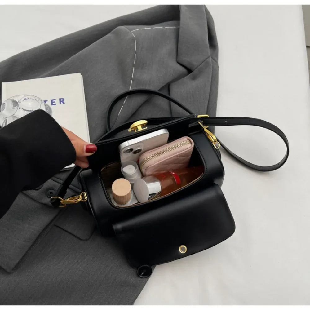 Black leather shoulder bag with textured flap, versatile retro-style crossbody handbag for women, large capacity and modern design.