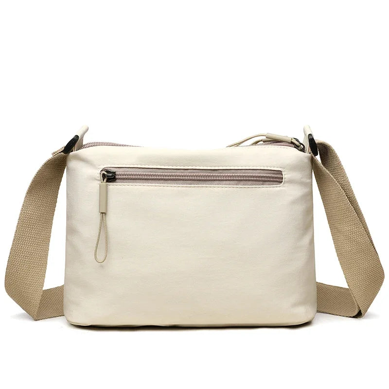High-capacity HSF Marketplace women’s canvas crossbody bag with three main pockets, ideal for mothers and shopping.