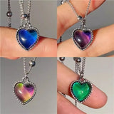 Thermochromic mood heart pendant necklace by HSF Marketplace showing color-changing effect, worn on a woman's clavicle chain.