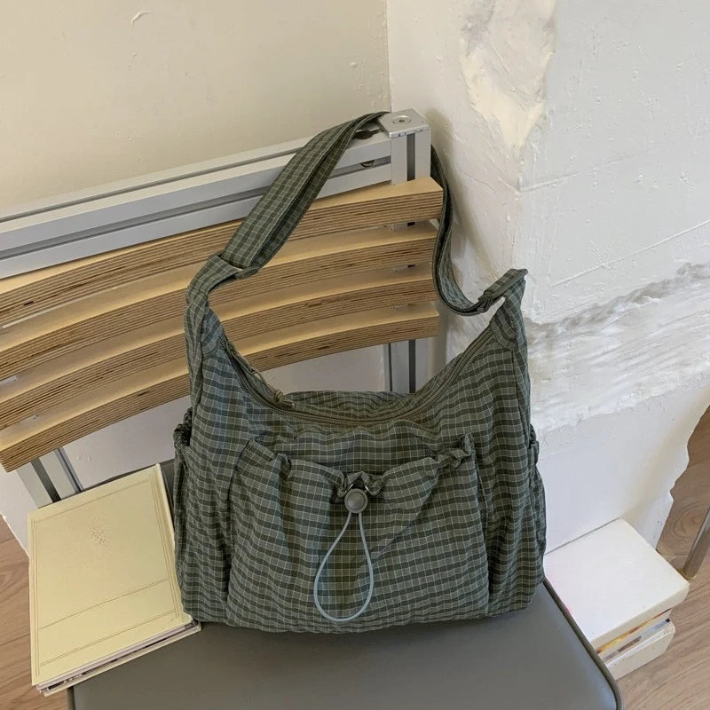 Women’s checkered sling bag by HSF Marketplace with nylon material, drawstring closure, large capacity, and trendy crossbody design.