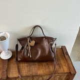 Luxury women's PU leather handbag with spacious design, shoulder strap, and stylish crossbody style for commuting and office use.