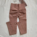 Women's high-waisted seamless leggings with peach butt-lifting fit, shown in a sleek quick-dry fabric for yoga and fitness