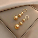 Gold-tone punk metal round bead tassel pendant earrings with glossy smooth ball details for women