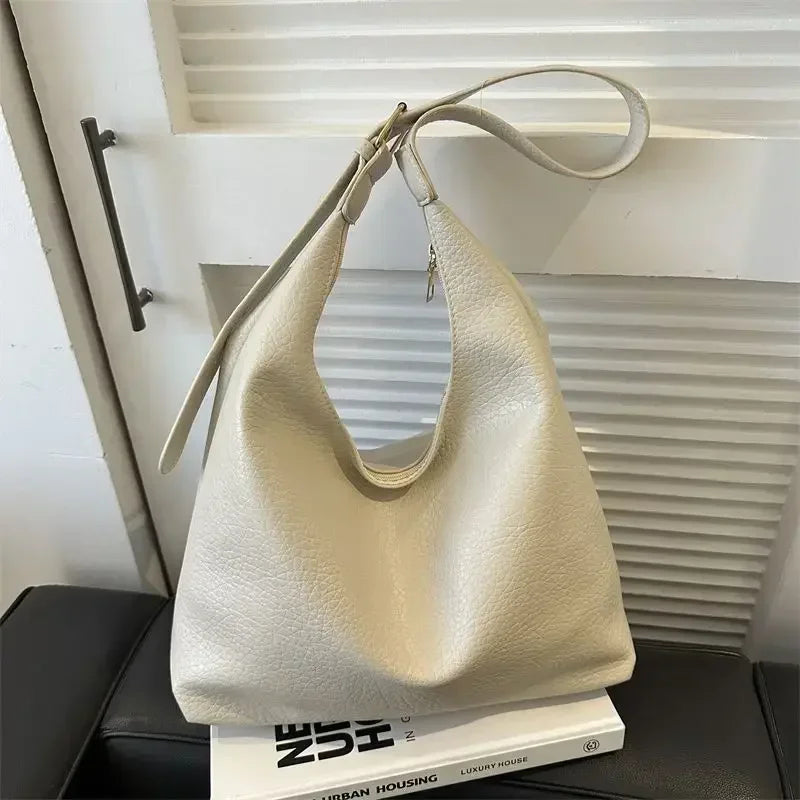 Large black leather tote bag for women featuring a simple, high-capacity shoulder design from HSF Marketplace.