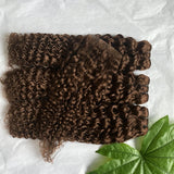 Chocolate brown human hair bundles with HD transparent lace closure, showcasing wet and wavy deep curly wave texture.