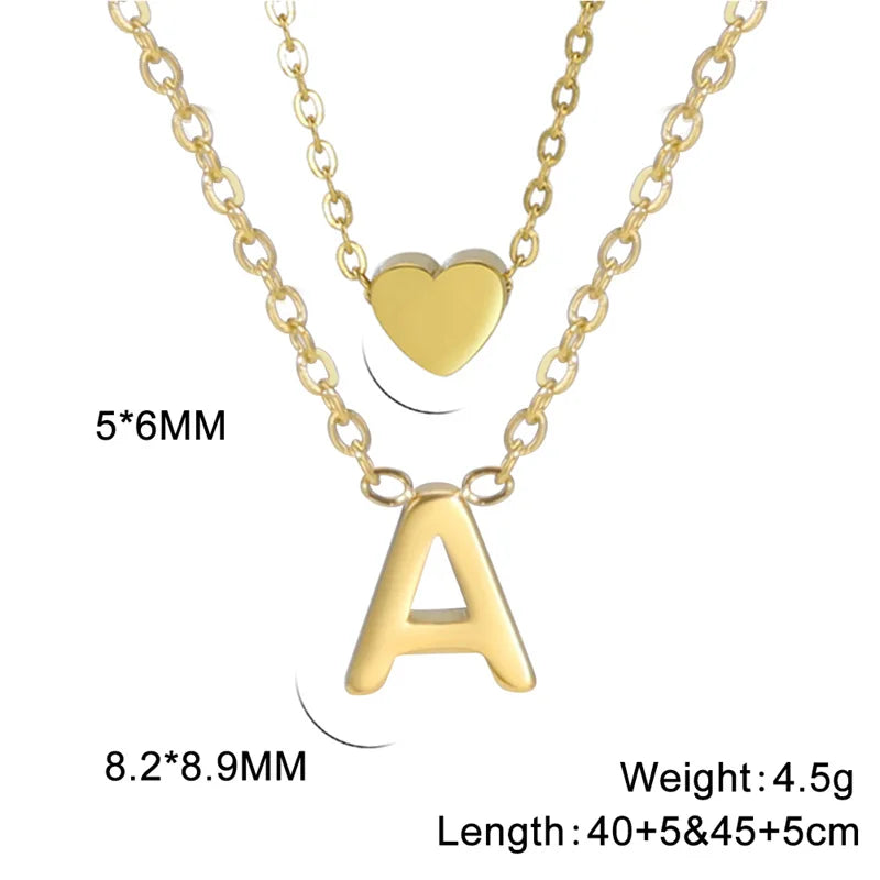 Tiny heart initial necklace for women with gold and silver layered charms, HSF jewelry brand