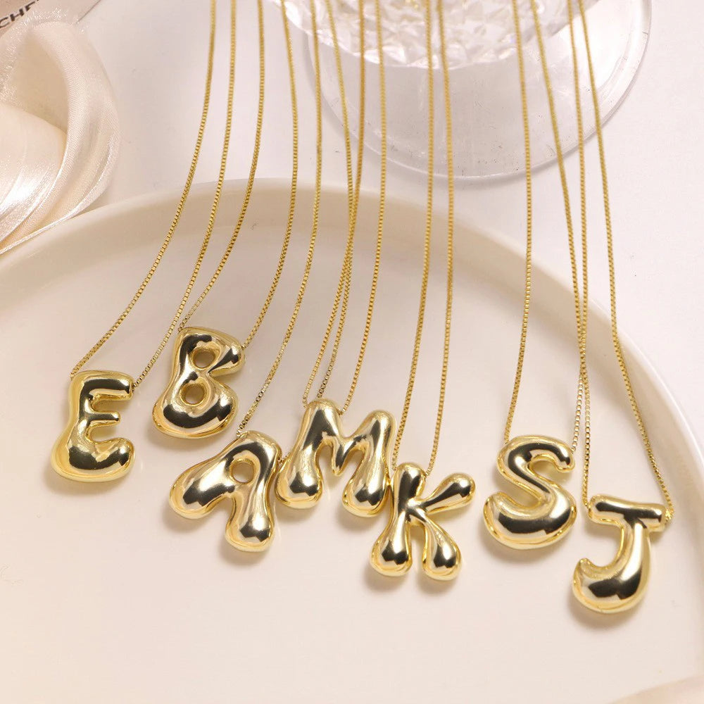 Golden stainless steel initial necklace for women and girls with chunky bubble letter pendant, trendy collar jewelry.