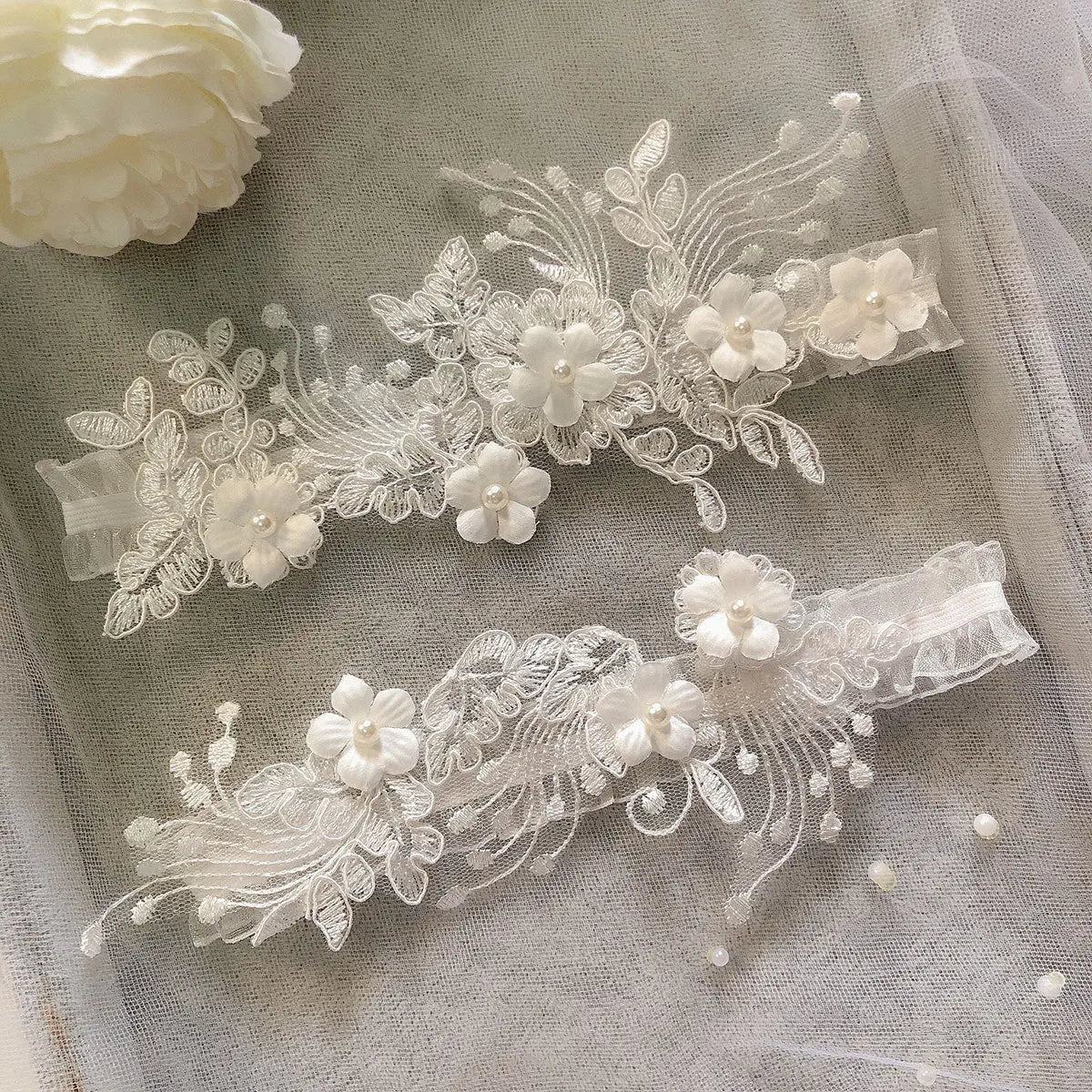 2-piece bridal garter thigh belt with pearl flower embroidery and elastic leg loops for weddings and parties