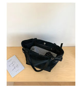 Black Rivet Design women's shoulder handbag with large capacity, elegant office style, featuring brand details and spacious interior.
