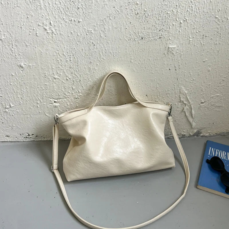 Luxury PU leather women's handbag with large capacity, shoulder strap, and stylish design for commuting and office use.