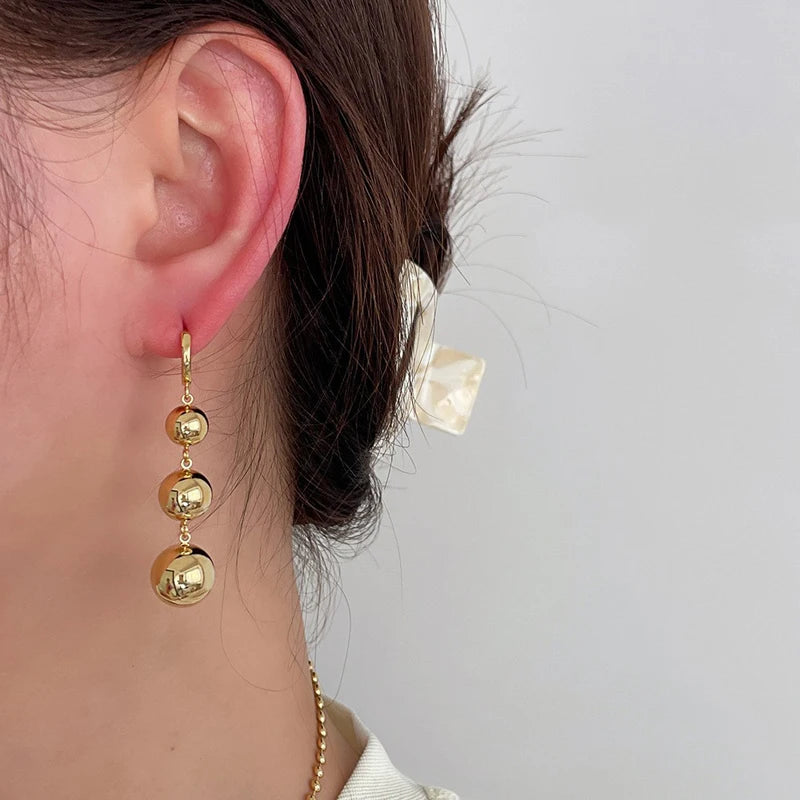 Gold-color punk metal round bead tassel pendant earrings with glossy smooth ball details for women by HSF Marketplace