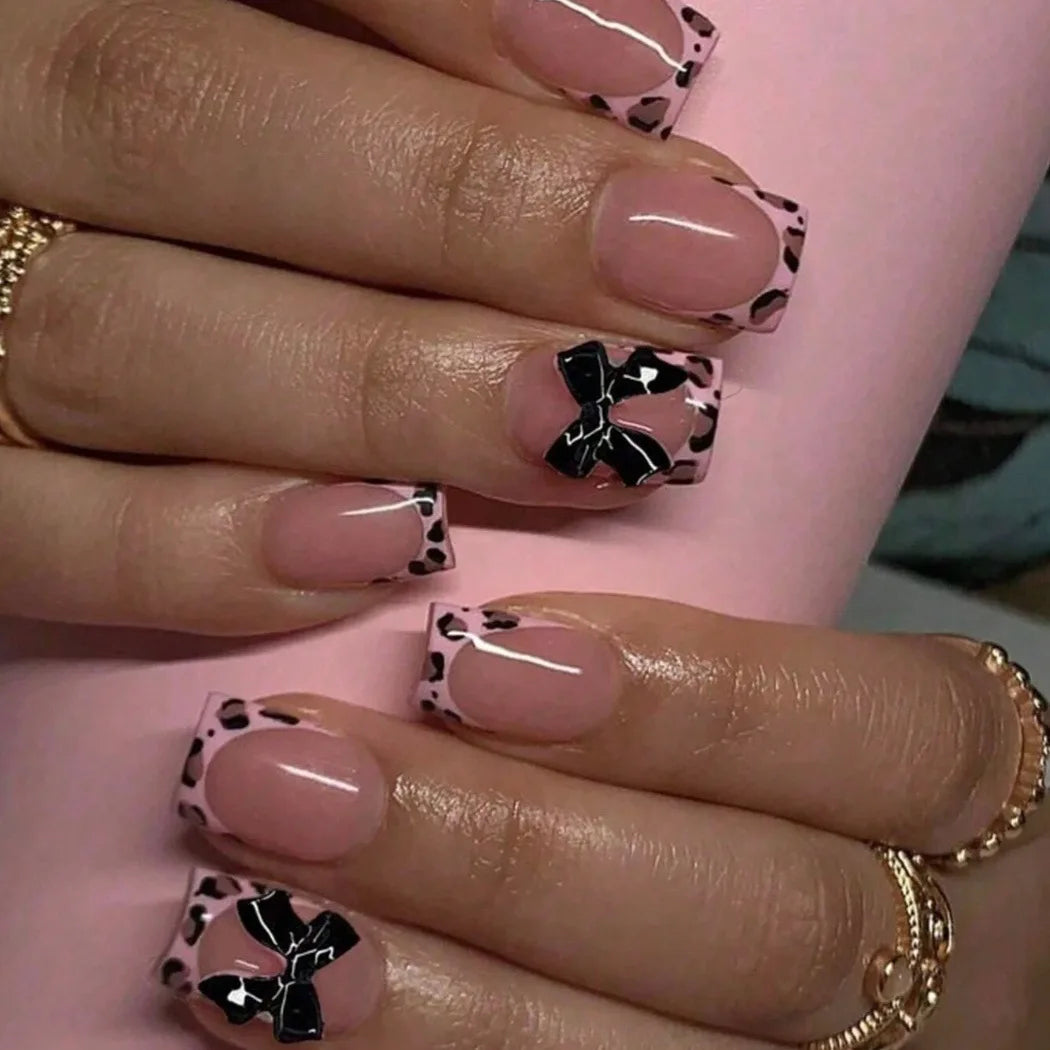 24-piece nude pink short duckbill press-on false nails with leopard print French tips, 3D bow, butterfly, and cherry designs