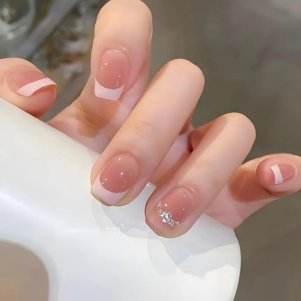 24-piece cute girly short square press-on false nails with white French tips, glitter stars, rhinestones, bows, and cat-eye design