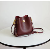 Large capacity burgundy PU leather women's handbag with shoulder strap and bucket style, elegant fashion tote and messenger bag.