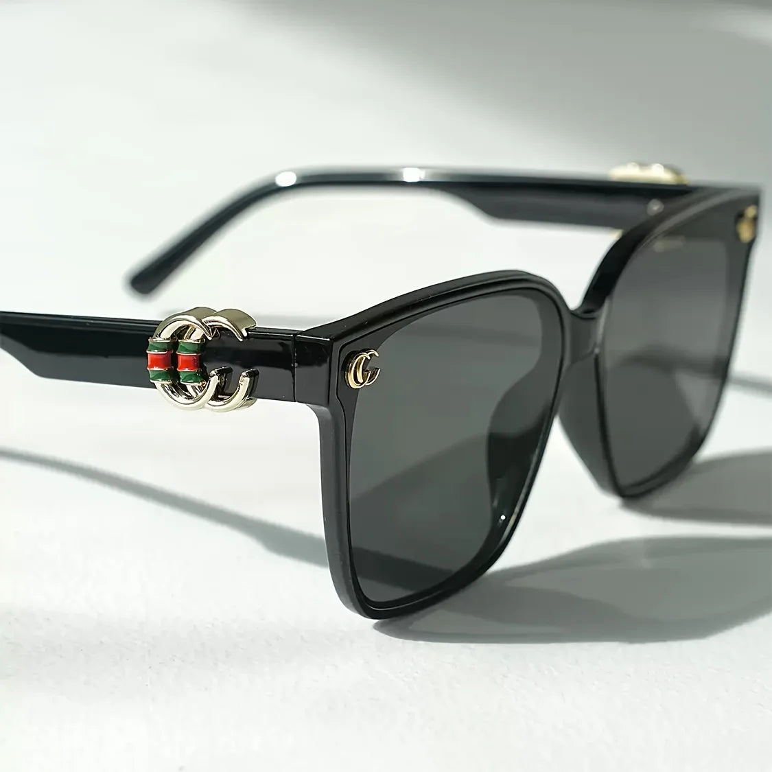 Women's luxury fashion sunglasses with floral details, letter accents, and UV400 lenses