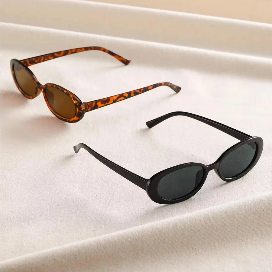Vintage oval sunglasses for women by HSF Marketplace featuring black and red retro design with small oval lenses.