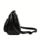 Black leather crossbody handbag with embossed design, featuring multiple pockets and a spacious interior, ideal for outings and parties.