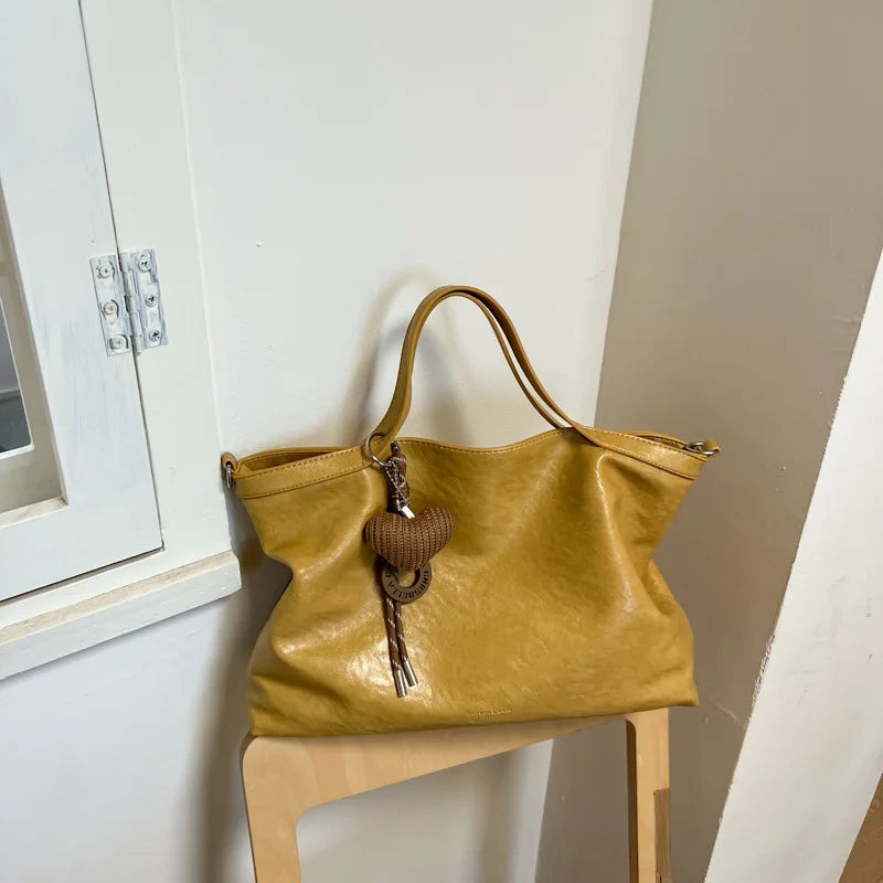 Luxury PU leather women's handbag featuring a spacious design, shoulder strap, and elegant style for commuting and office use.