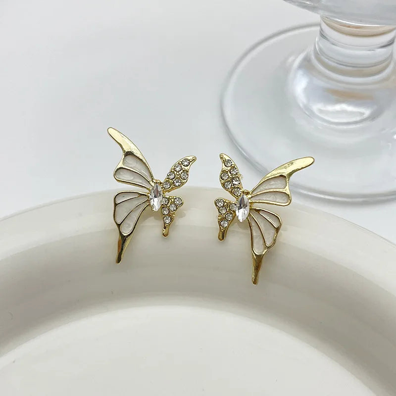 White enamel butterfly stud earrings with crystal wings in golden color metal, HSF Marketplace jewelry