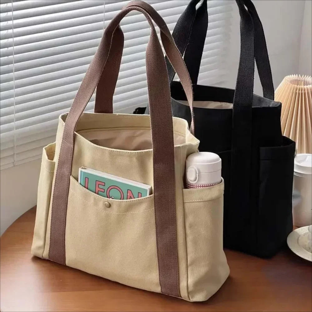 Large capacity canvas tote bag by HSF Marketplace, casual college-style shoulder bag for work, commuting, and carrying books.
