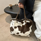Large capacity women's winter tote bag with cow print plush design, suitable for travel and everyday use, by HSF Marketplace.