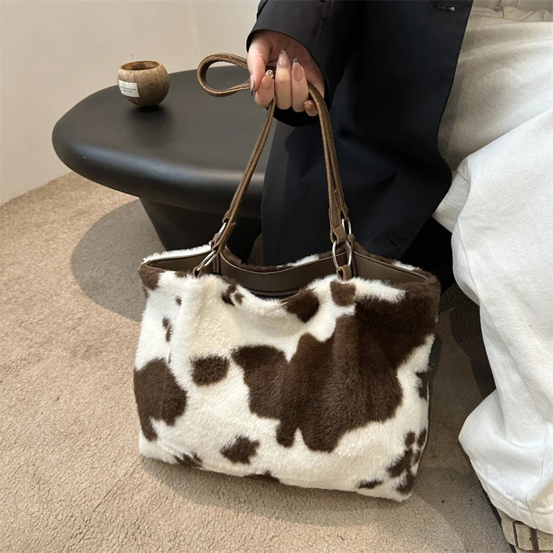 Large capacity women's winter tote bag with cow print plush design, suitable for travel and everyday use, by HSF Marketplace.
