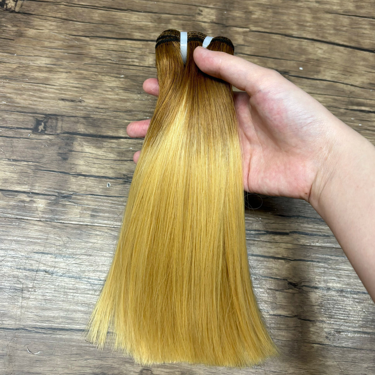 Two 6-inch lace closure and 8 and 10-inch colored Vietnamese human hair bundles with ombre shades and double drawn Remy hair extensions.