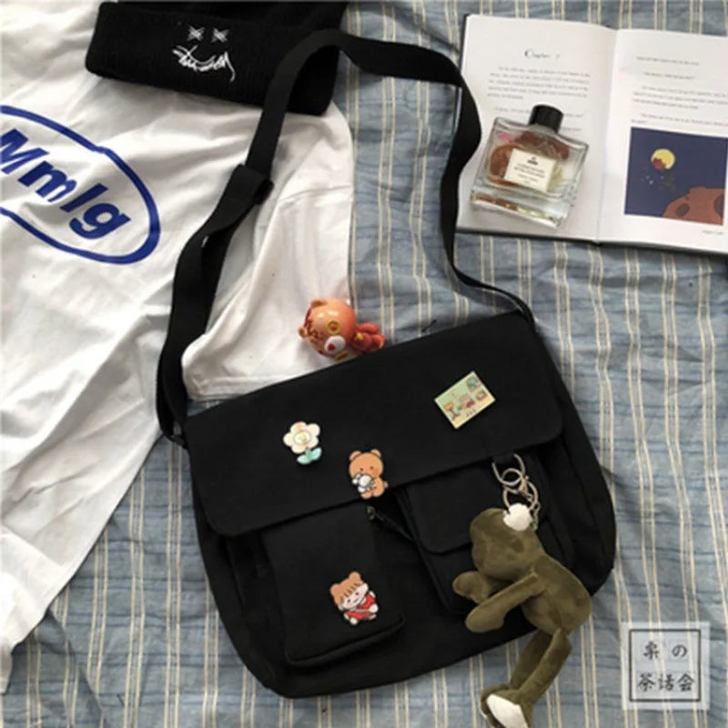 Women’s casual canvas messenger bag with printed design, shoulder strap, and compact pouch style, ideal for school or everyday use.