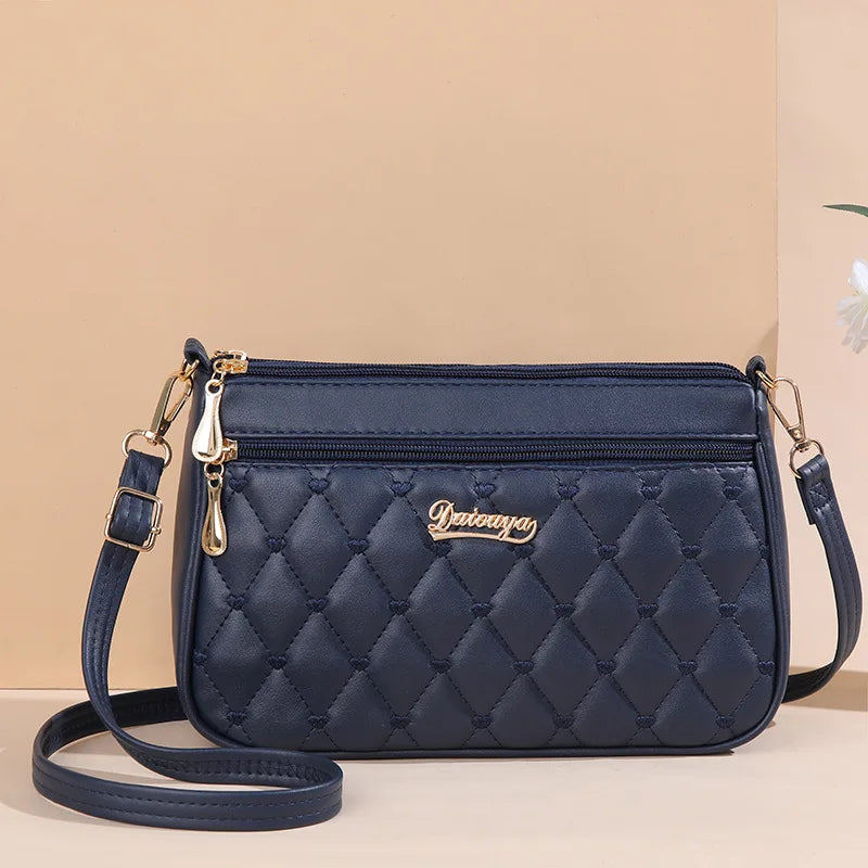 PU leather crossbody handbag with zipper, embroidery thread design, large capacity, fashionable shoulder bag for women.