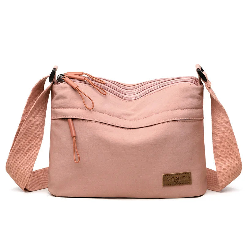 High capacity HSF Marketplace women's shoulder crossbody handbag with three main pockets and multiple compartments in canvas style.