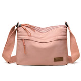 High capacity HSF Marketplace women's shoulder crossbody handbag with three main pockets and multiple compartments in canvas style.