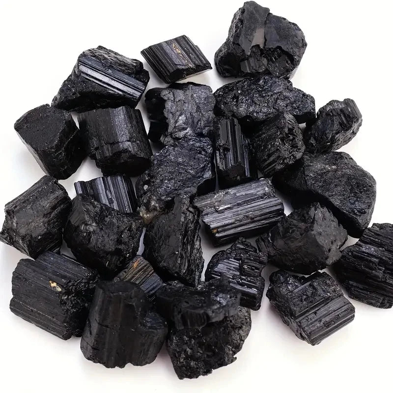 Natural black tourmaline crystal stones in raw ore form, irregular mineral specimen, showcasing rough black mineral crystals.