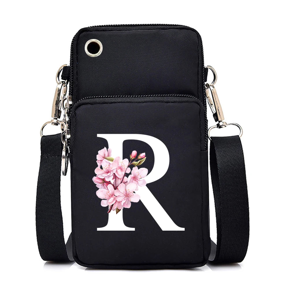 Small floral alphabet crossbody bag for women, HSF Marketplace, with pink and white Sakura letter graphics and mobile phone compartment.