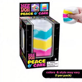 Colorful NeeDoh Piece O' Cake squishy toy from HSF Marketplace, layered rainbow cake design for sensory play and stress relief.