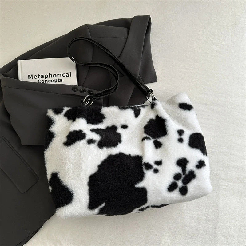 Large cow-print plush women's shopper tote bag with shoulder strap, ideal for winter travel and everyday use.