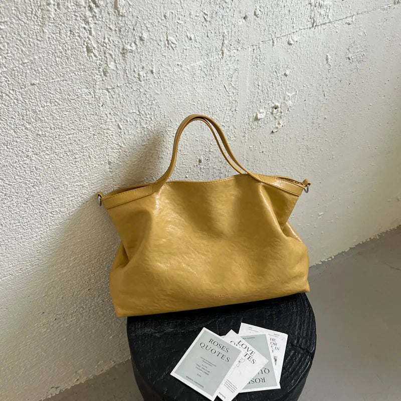 Luxury PU leather women's shoulder handbag with large capacity, stylish design, ideal for commuting and office use.