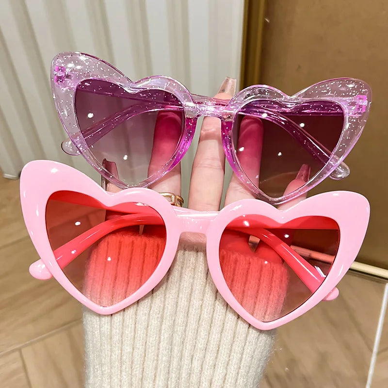 Pink heart-shaped vintage sunglasses for girls, shiny transparent frames, perfect for beach parties and birthday photos.