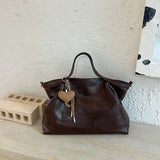 Luxury black PU leather women's handbag with spacious design, shoulder strap, and elegant tote style for commuting and office use.