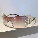 Y2k rimless sunglasses for women with snake pattern design, gradient lenses, metal legs, and wrap-around punk style eyewear.