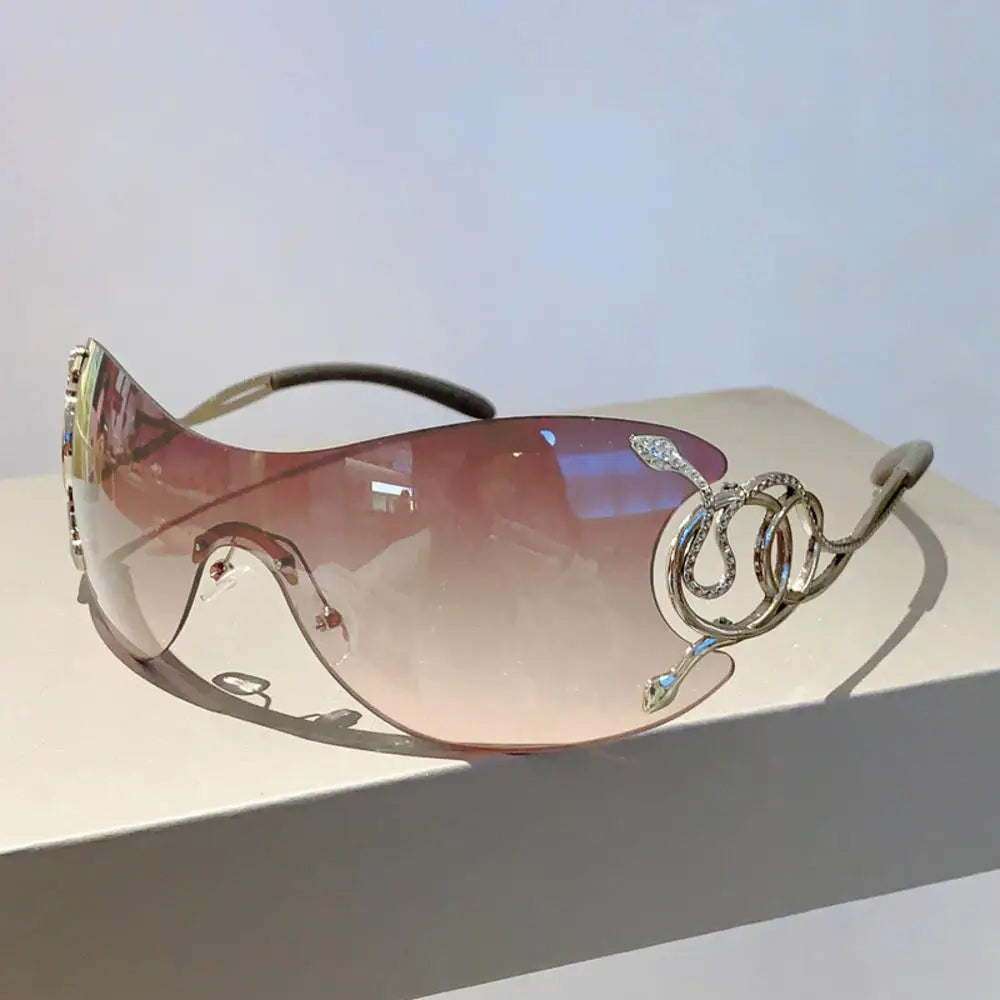 Y2k rimless sunglasses for women with snake pattern design, gradient lenses, metal legs, and wrap-around punk style eyewear.