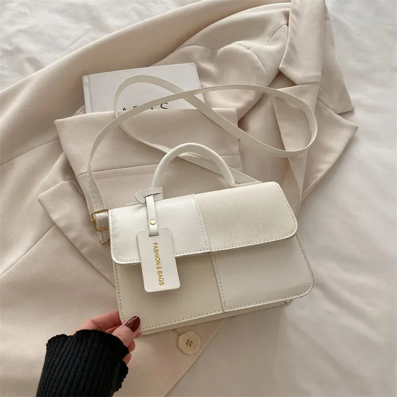 Elegant women's crossbody handbag with geometric pattern, snap closure, and shoulder strap, stylish accessory for everyday use.