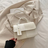 Elegant women's crossbody handbag with geometric pattern, snap closure, and shoulder strap, stylish accessory for everyday use.