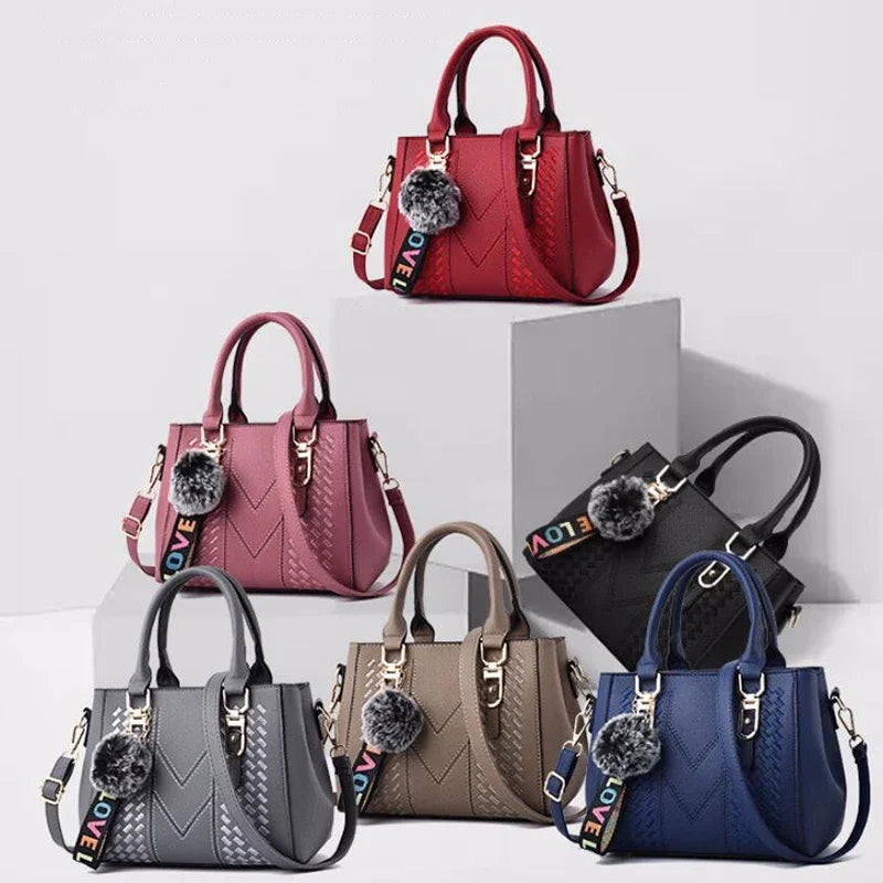 Leather messenger handbag for women with embroidery and hairball design, stylish leather purse for everyday use.